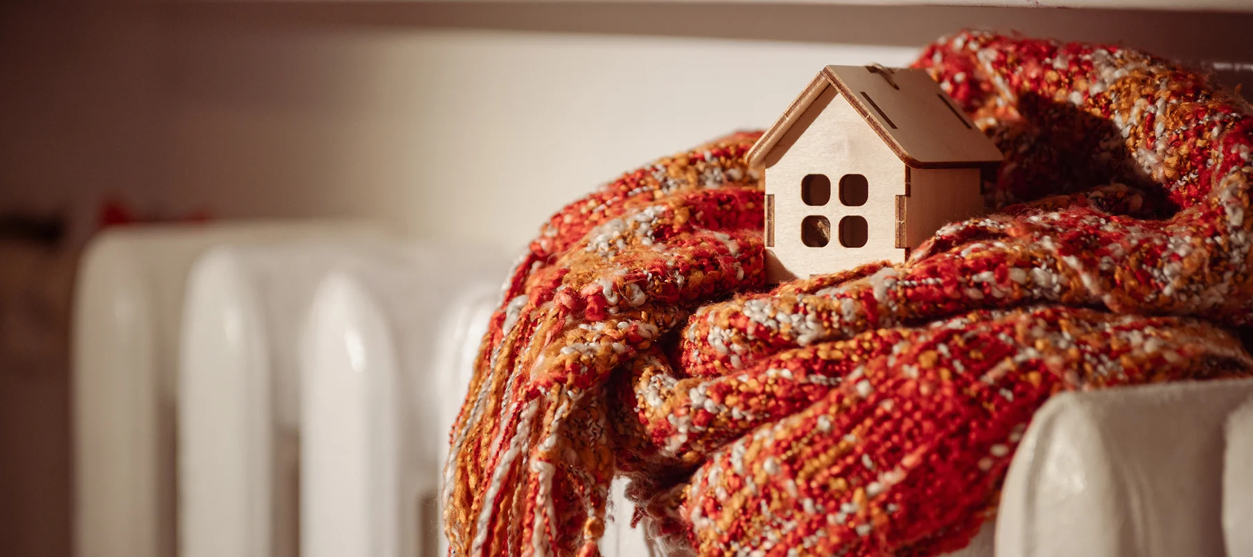 scarf and home ornament resting on warm radiator