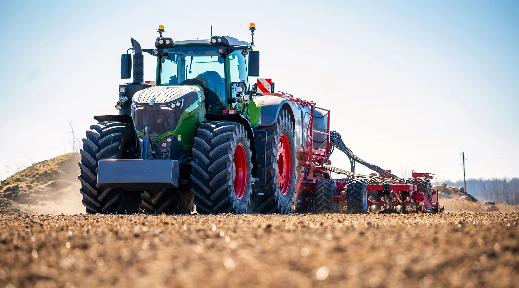 tractor pulling a seeding machine on a farm