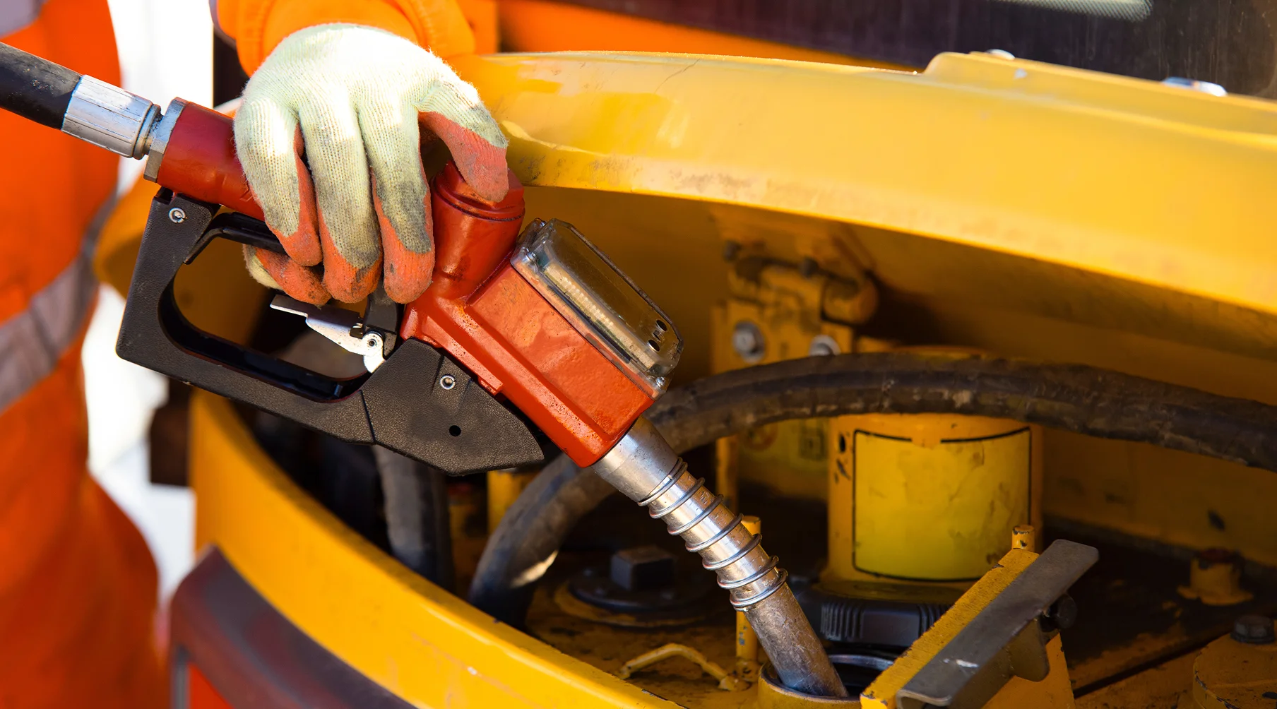 construction equipment being filled with red diesel from a pump
