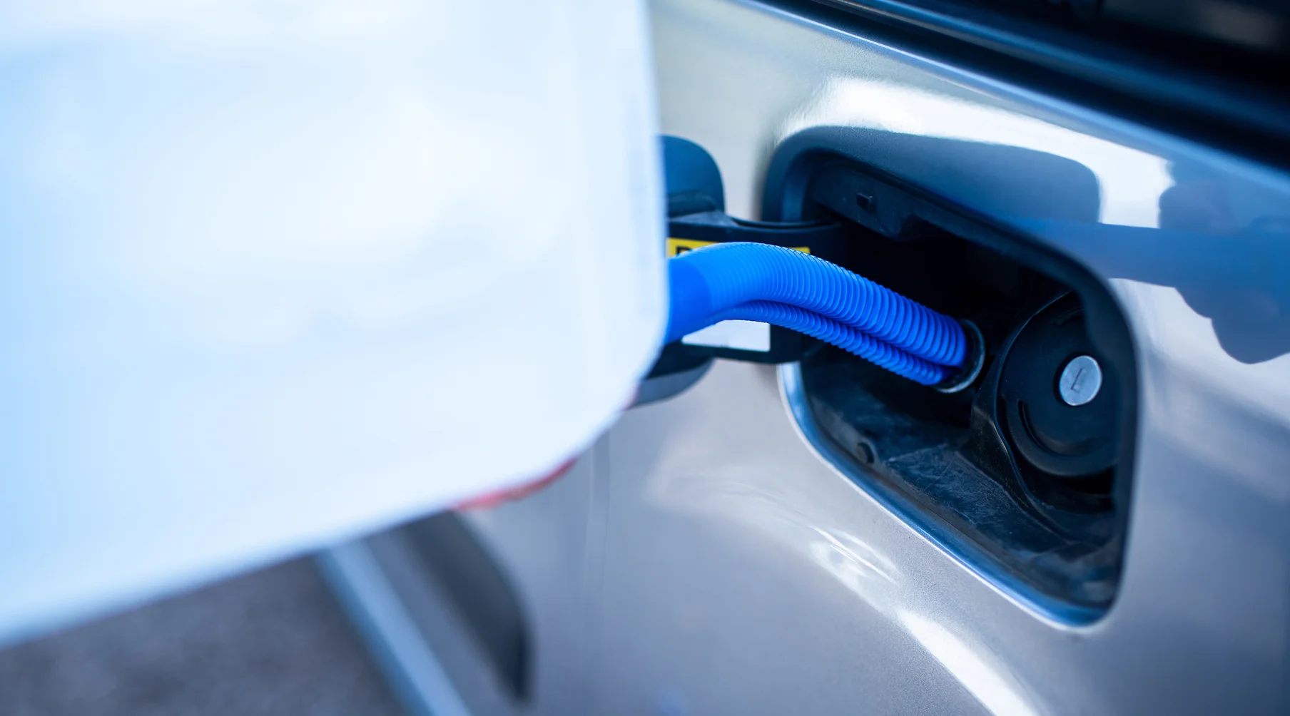 Driver filling their car with adblue after checking how long does adblue last