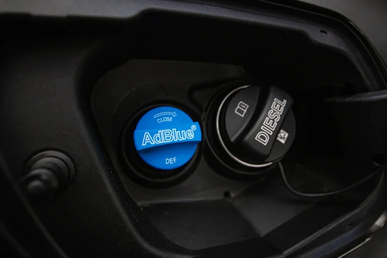 adblue filler cap next to diesel filler cap on a car